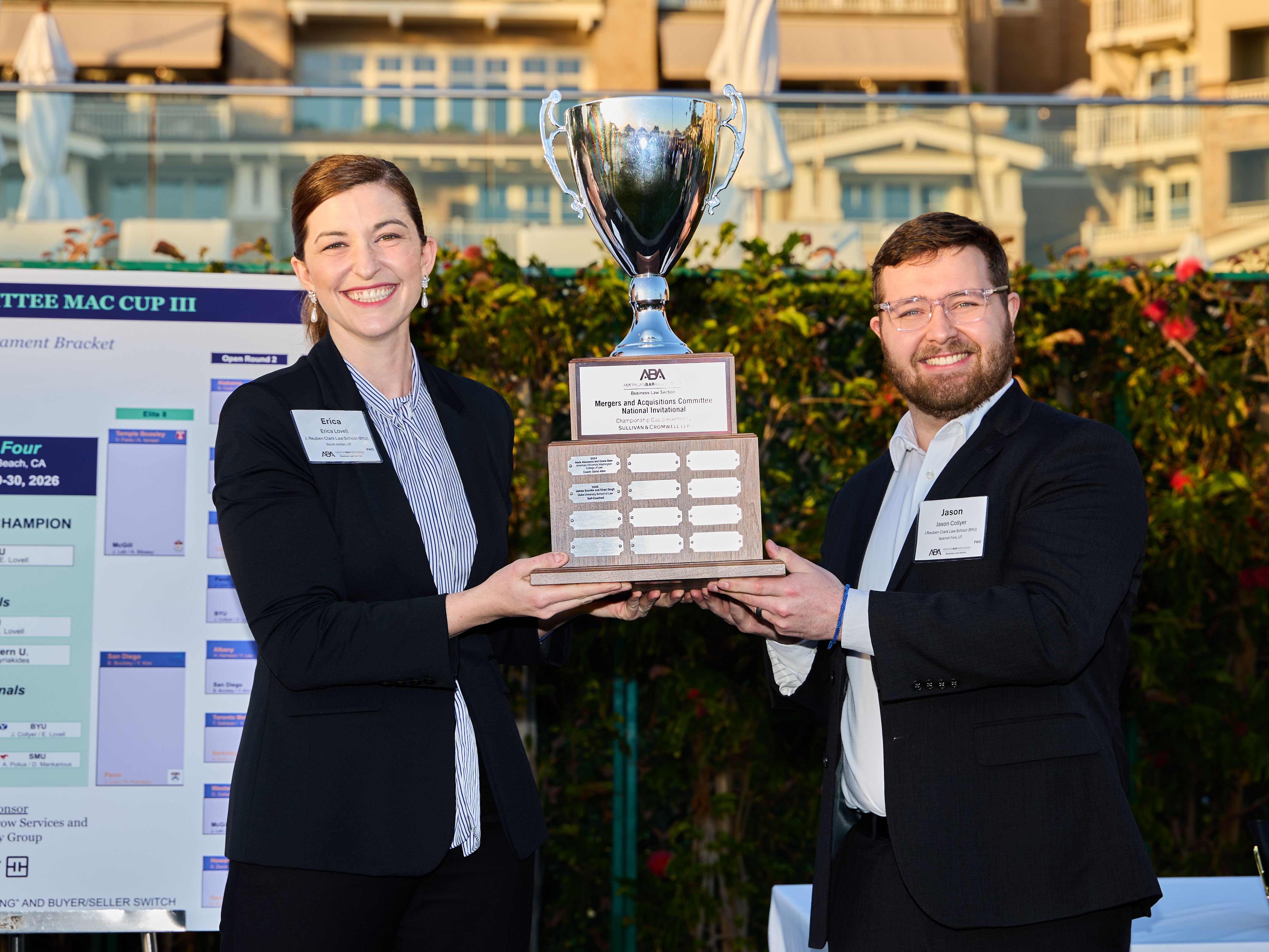 BYU Law students Erica Lovell and Jason Collyer hoist the ABA MAC Cup
