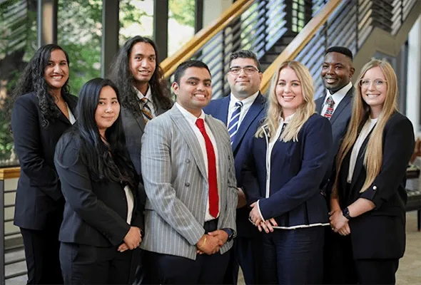 A group of lawyers standing together facing the camera